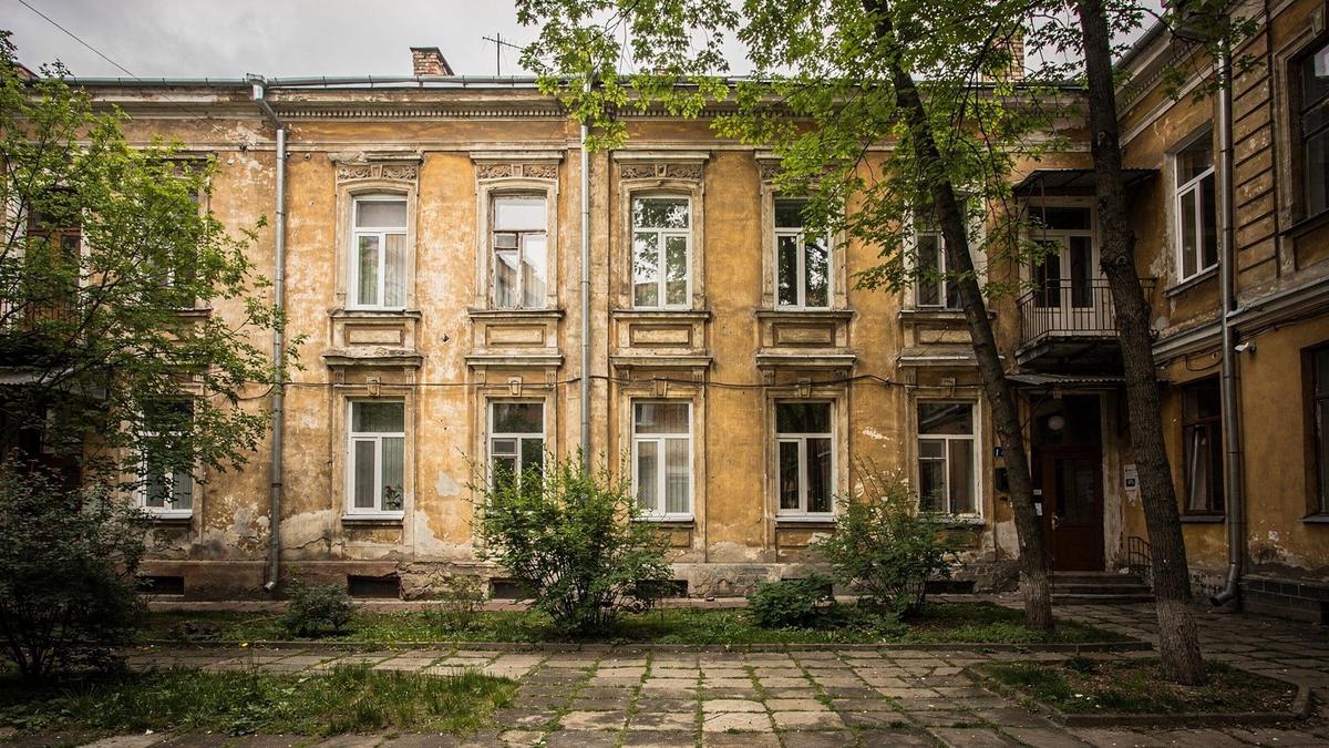 Restored early twentieth century apartment building beside a quiet Podil courtyard